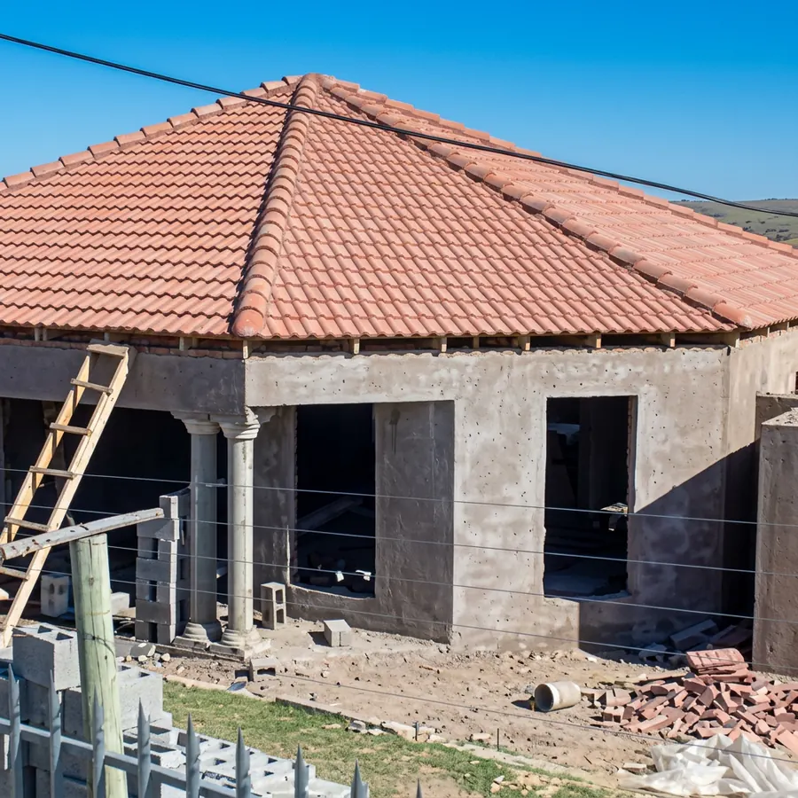Residential construction site with tiled roofing and brickwork